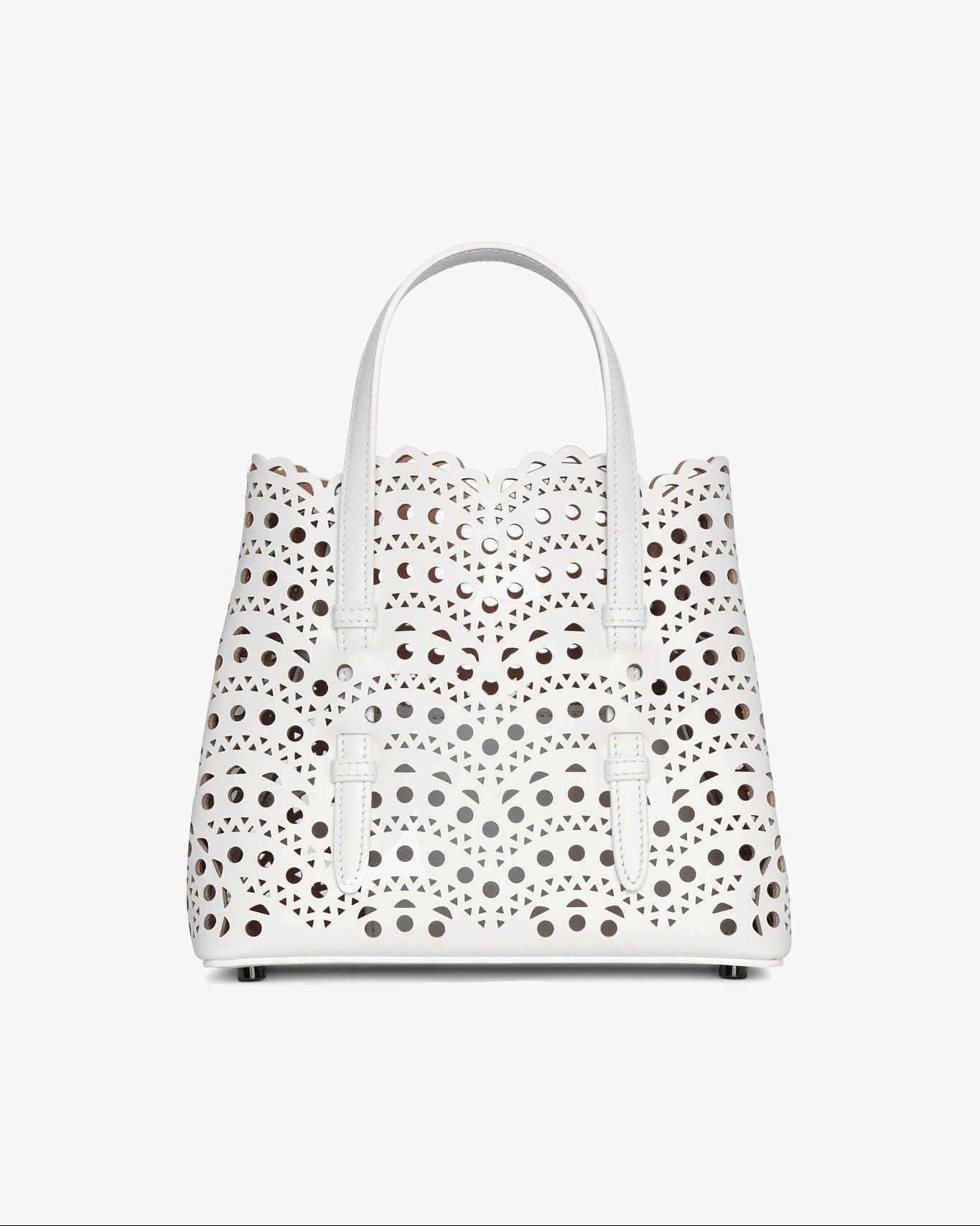White handbag with black polka dot pattern on a white background