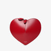 Red heart-shaped handbag with a bow on a light gray background