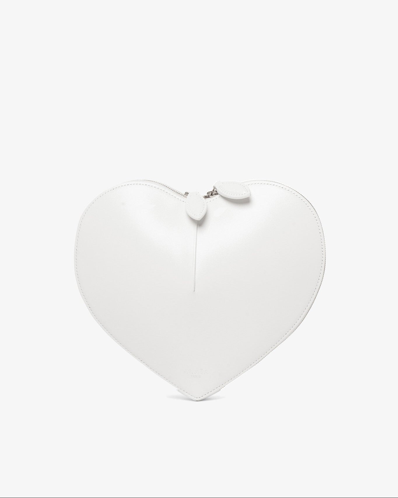 Heart-shaped white pillow on a white background