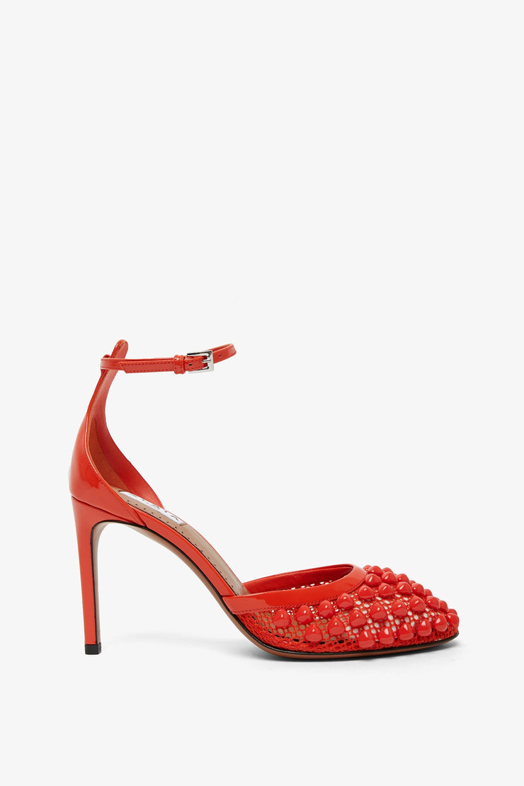 Red studded fishnet pumps