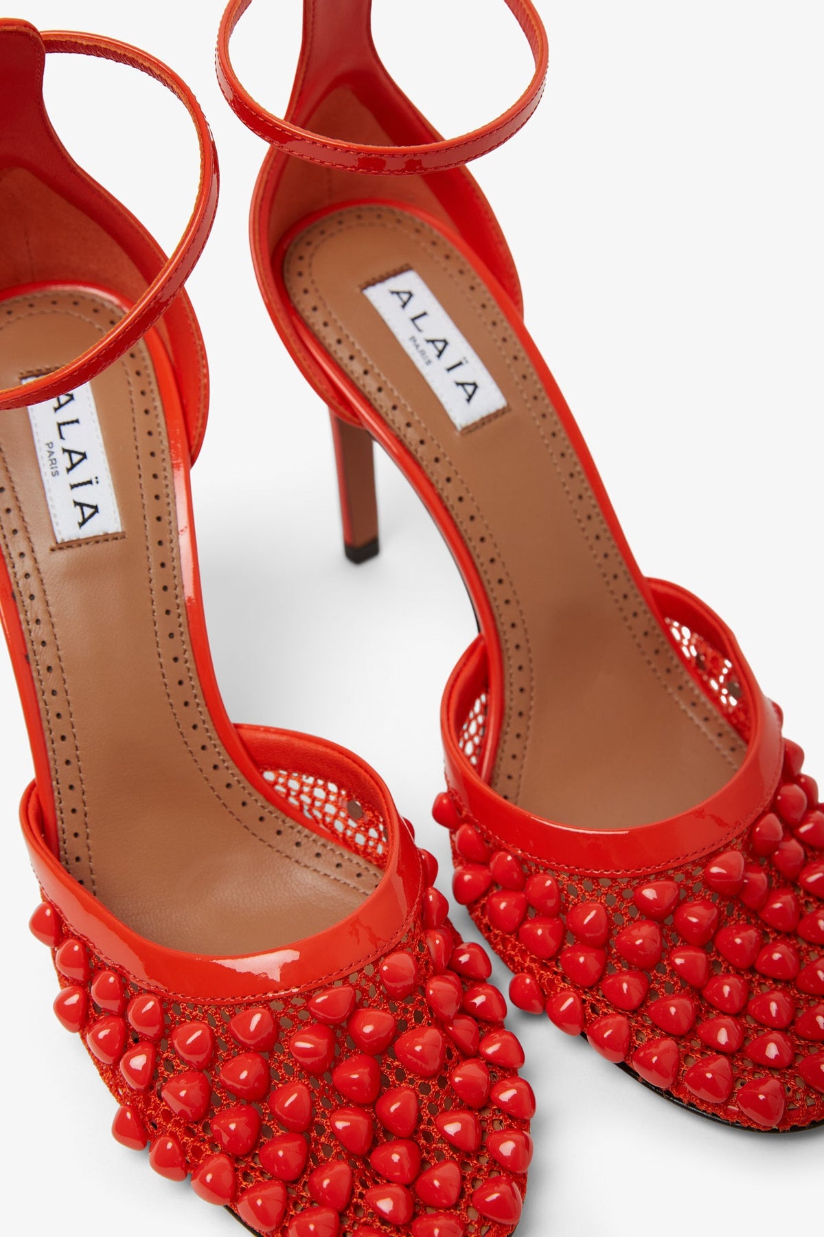 ALAÏA RED STUDDED FISHNET PUMPS 