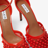 Red studded fishnet pumps