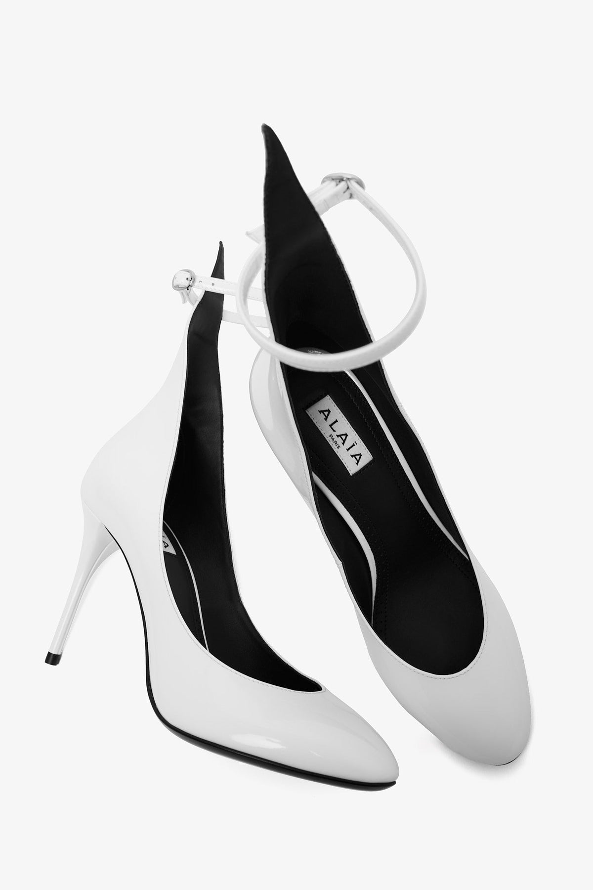 Shop Alaïa Pumps 90 White Patent Pumps