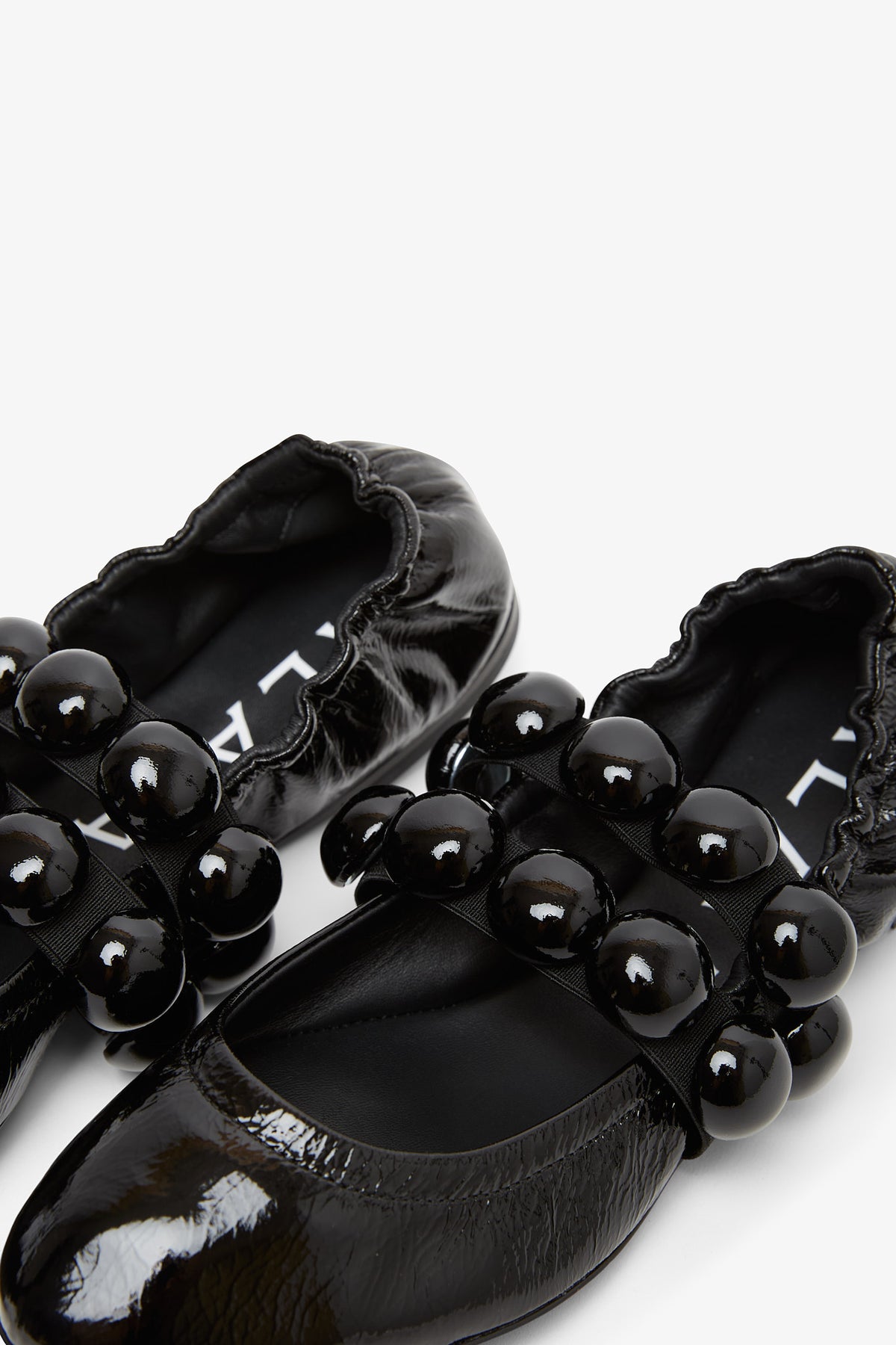 Shop Alaïa Sphere Patent Leather Ballerinas