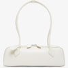 White handbag with a bow detail on a white background