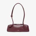 Maroon handbag on a light beige background