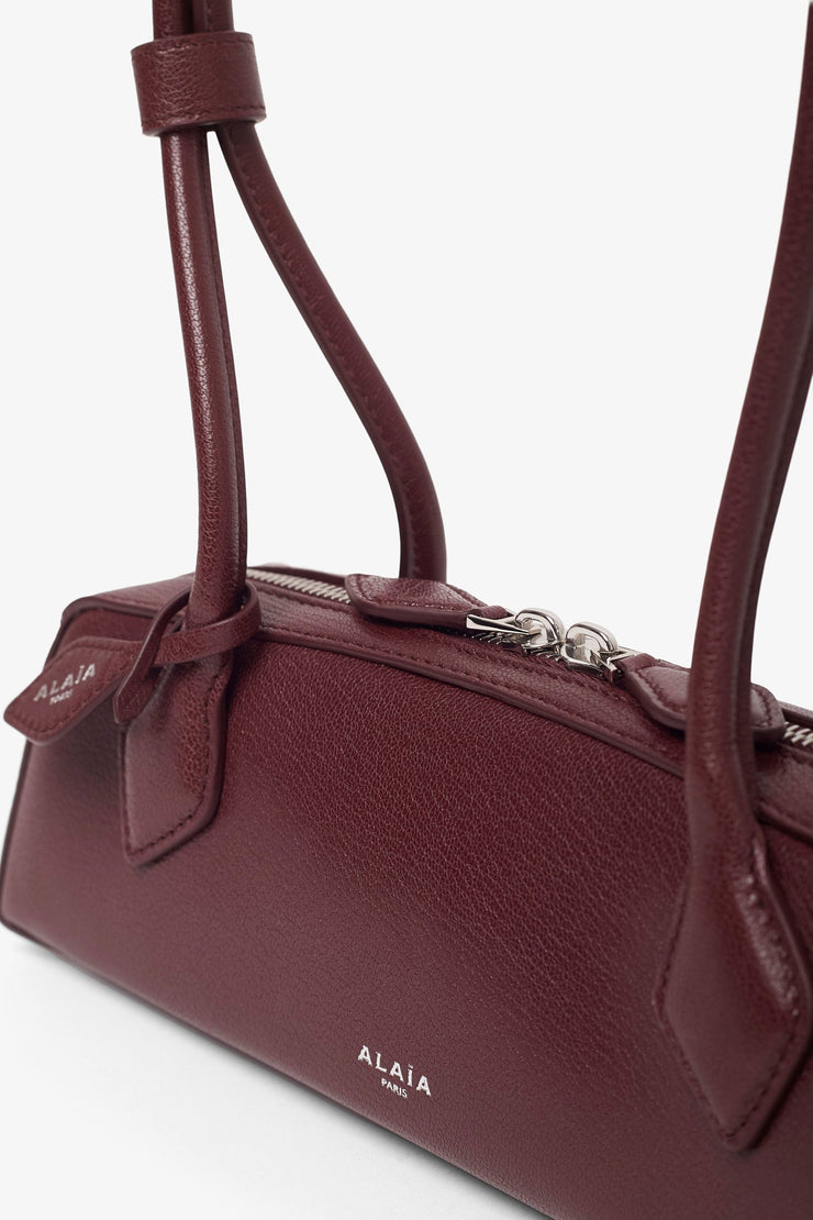 Le Teckel small dark red leather bag