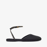 Black flat sandal with studded detail on a white background