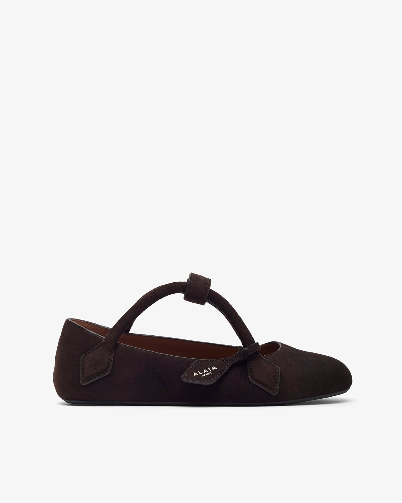 Brown flat shoe with a bow on a white background