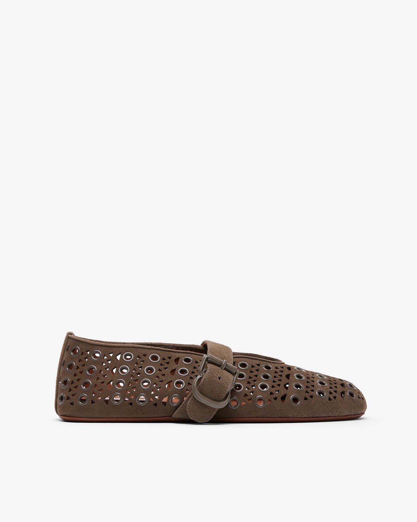 Brown loafers with decorative holes and a buckle on a white background