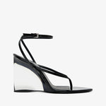 Black wedge sandal with transparent sole on a white background