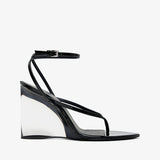 Black wedge sandal with transparent sole on a white background