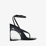 Black high-heeled sandal with clear heel on a white background