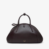 Brown leather handbag with a handle on a white background