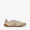 Beige slip-on shoe with a white sole on a light beige background