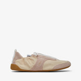 Beige slip-on shoe with a white sole on a light beige background