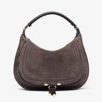 Brown suede handbag with gold hardware on a white background