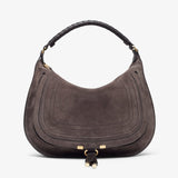 Brown suede handbag with gold hardware on a white background
