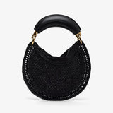 Black woven handbag with a gold handle on a white background
