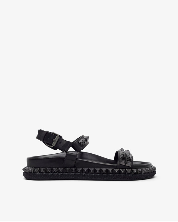 Black sandal with studded details on a white background