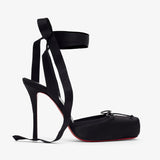 Black high-heeled shoes with ribbon straps on a white background