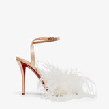 High-heeled shoe with a decorative strap and white feather details on a light gray background