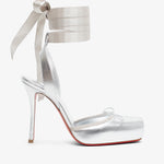 Silver high-heeled sandal with ribbon detail on a white background
