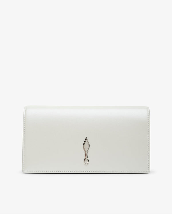 Pointed-toe shoe with beige leather sole and black heel on a white background