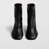 Tug black leather ankle boots