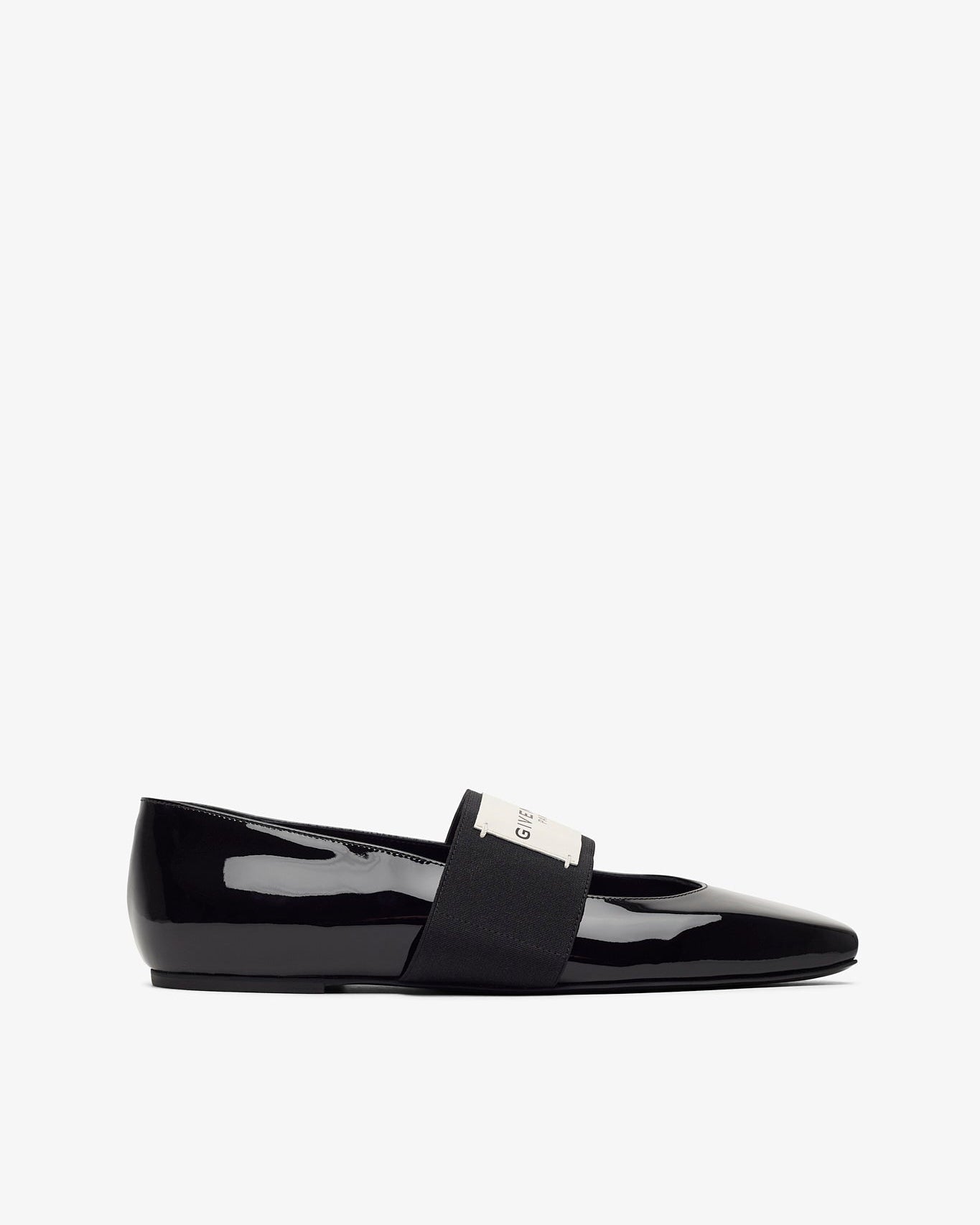 Black patent leather loafer on a white background
