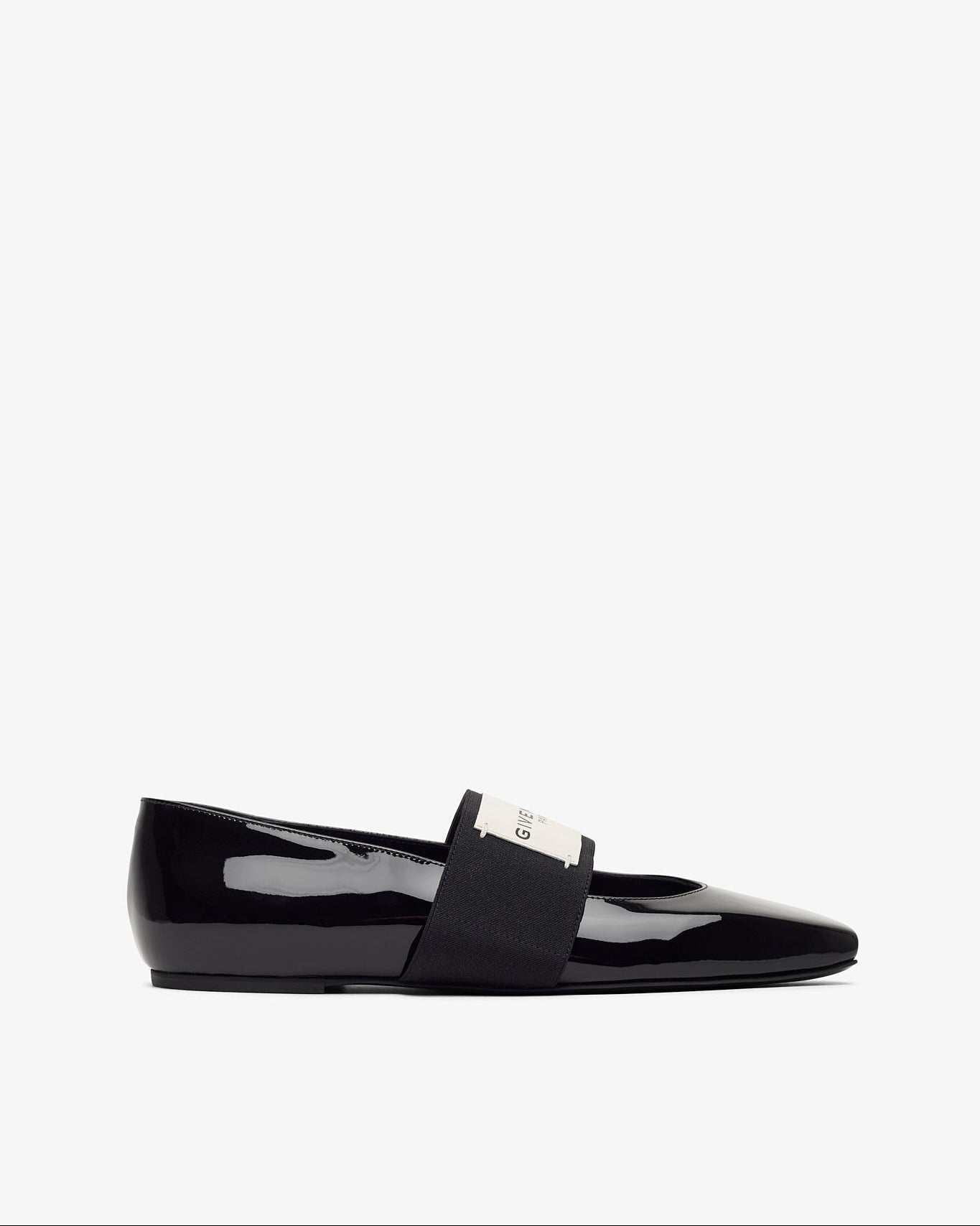 Black patent leather loafer on a white background