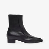 Black ankle boots on a white background