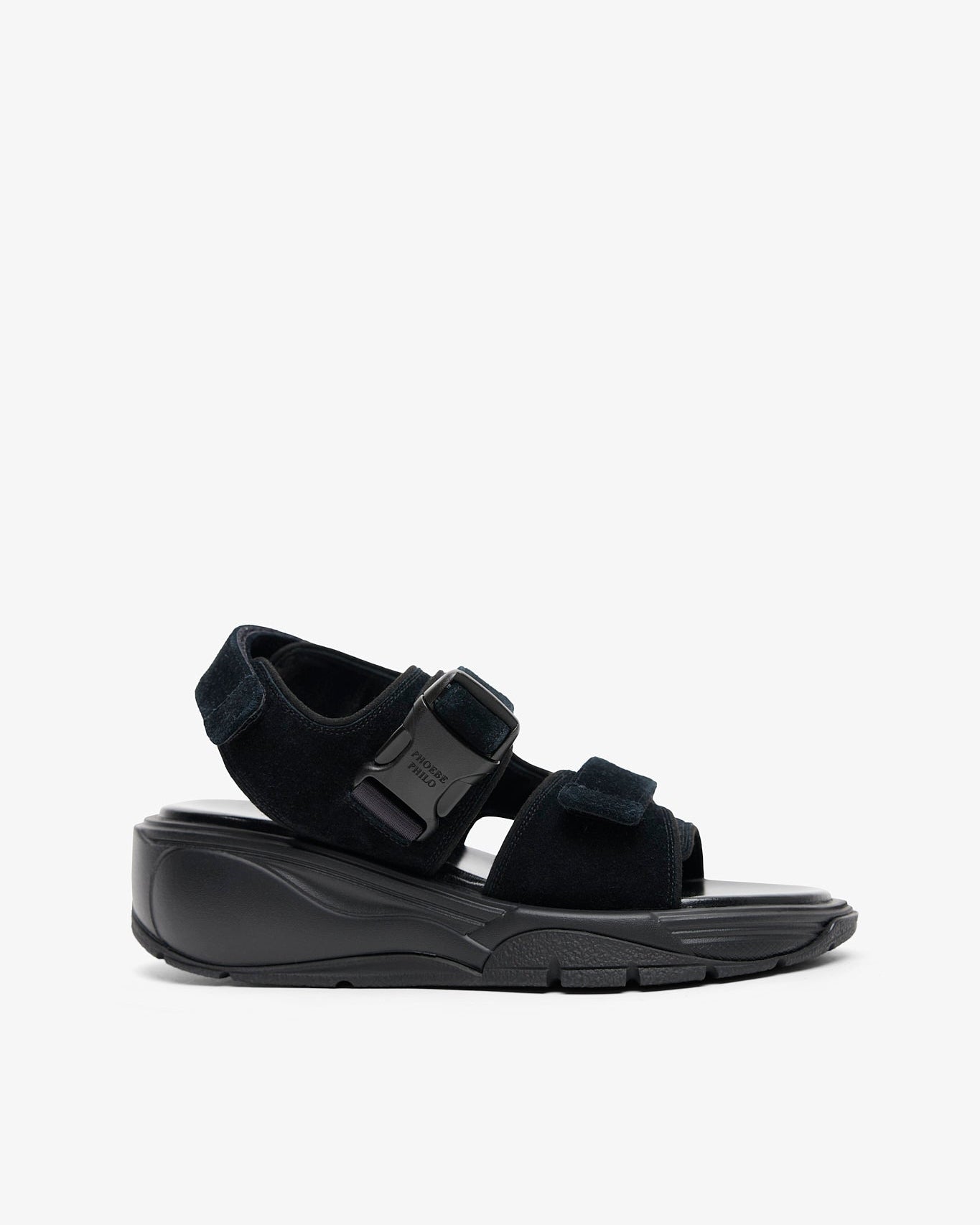 Black sandal with a thick sole on a white background