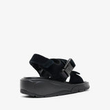 Black sandal with a strap on a white background