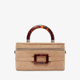 Beige handbag with tortoiseshell accents on a white background