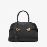 Black handbag with gold accents on a white background