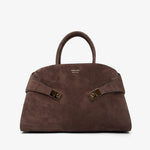 Brown handbag with gold accents on a white background