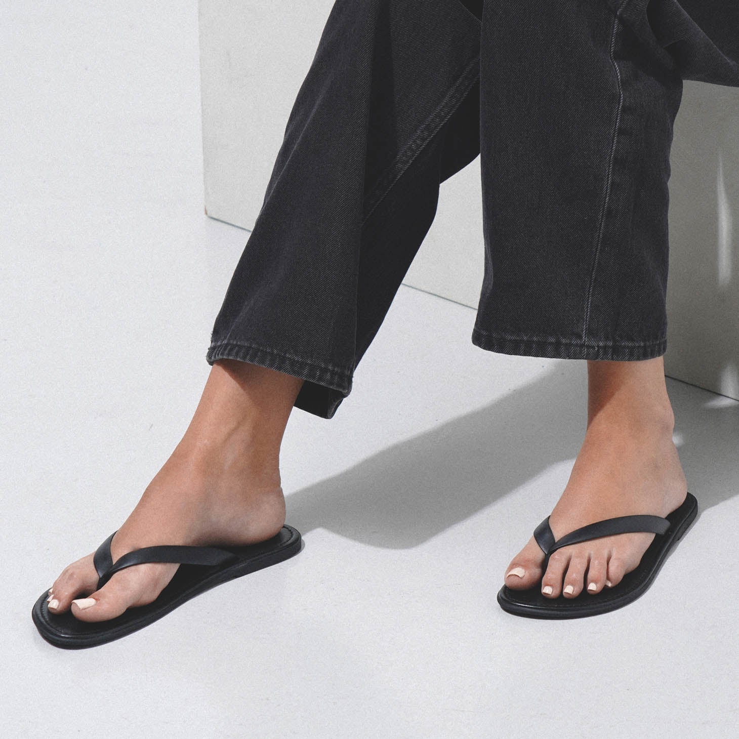 The Row | Beach black flip flop sandals | Savannahs