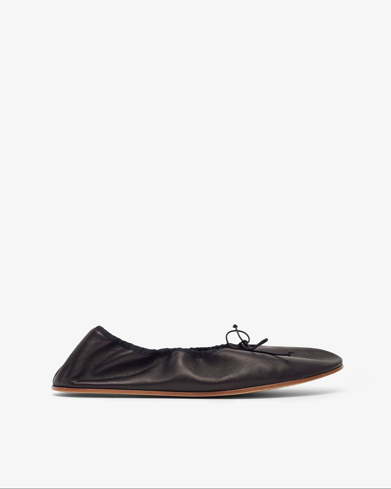 Black leather flat shoe on a white background