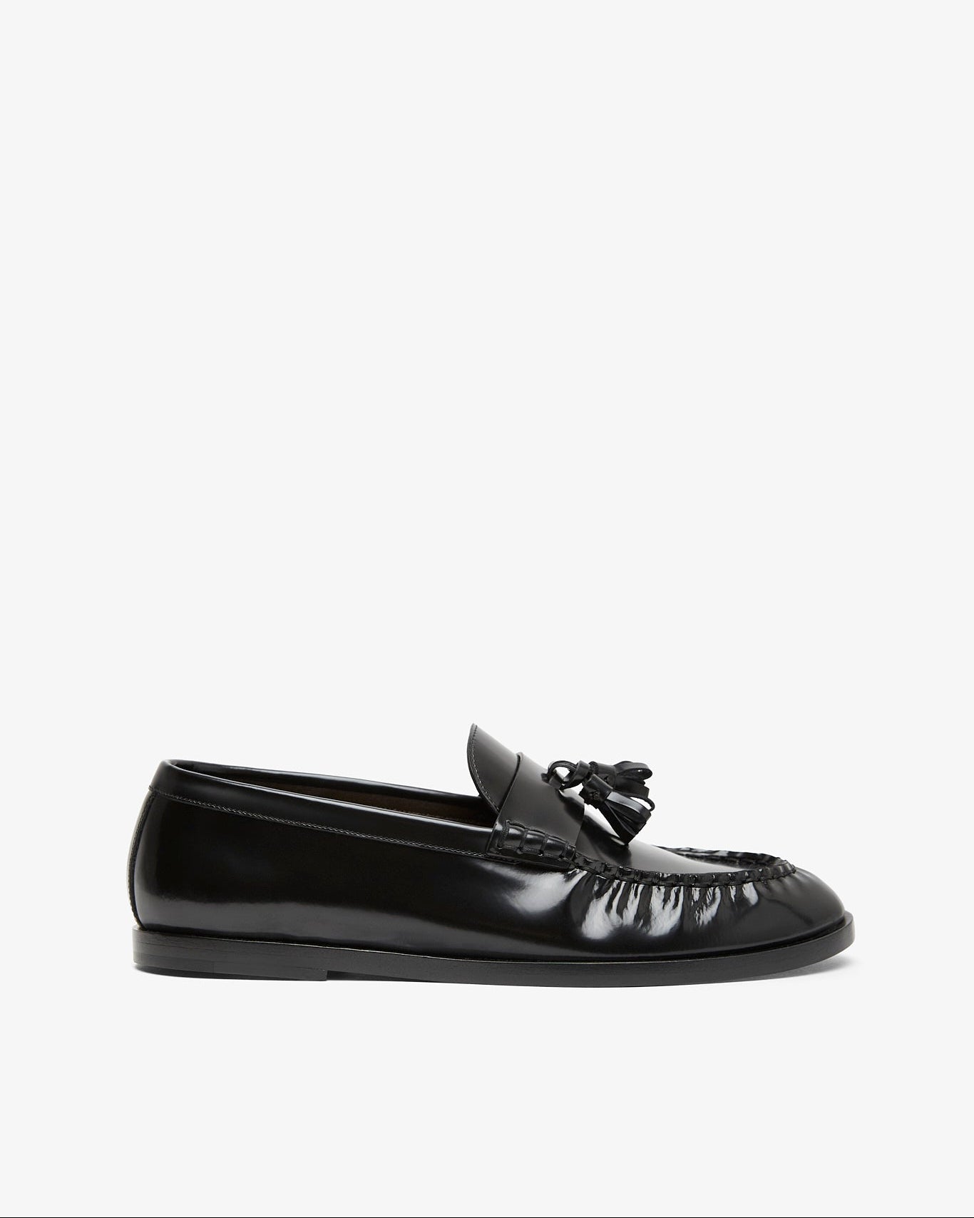 Black loafers with tassel on a white background