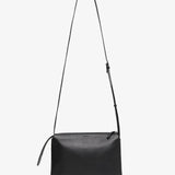 Black leather crossbody bag on a white background