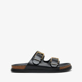 Black sandal with gold buckles on a white background