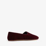 Burgundy velvet loafer on a white background