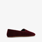 Burgundy velvet loafer on a white background