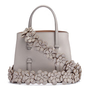 Grey leather mini tote with studded floral strap