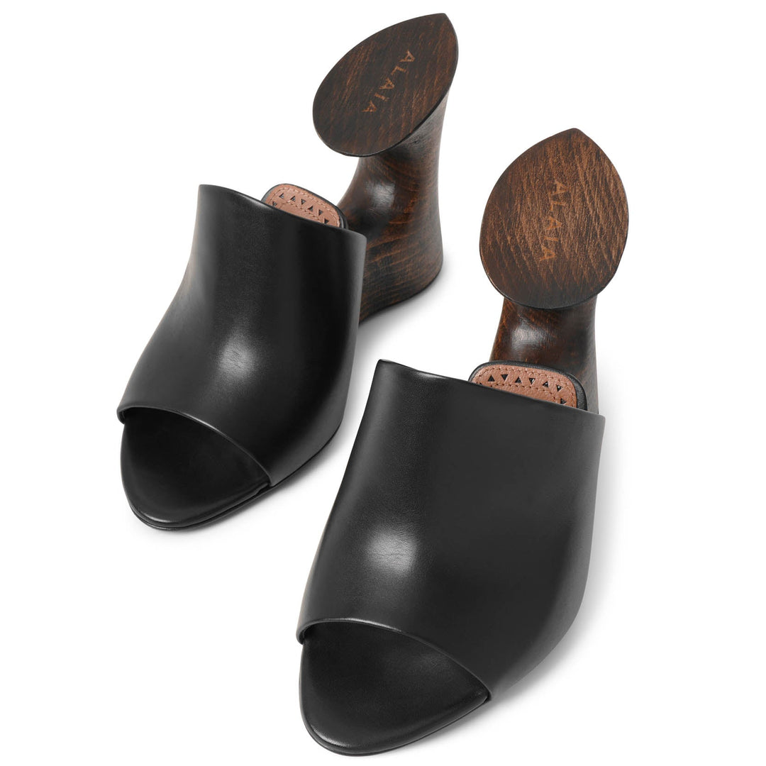 Alaïa | La Sculpture black leather wedge mules | Savannahs