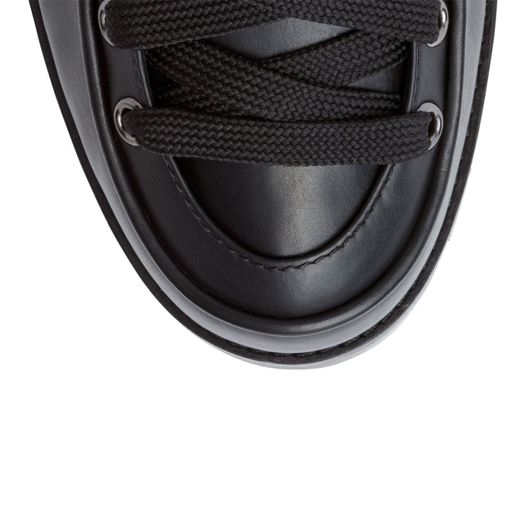 Christian Louboutin | Who Runs black leather boots | Savannahs